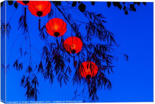 Red vietnamese or chinese lanterns contrasting with a blue sky Canvas Print by SnapT Photography