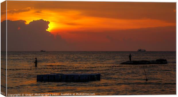 A silhouette of fishermen standing on rocks at sun Canvas Print by SnapT Photography