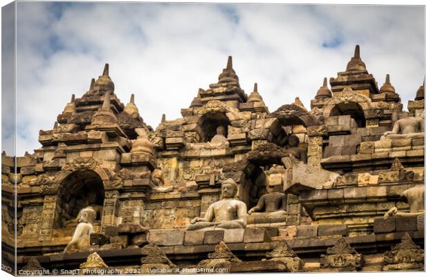 The upper section of the Borobudur Buddhist temple and clouds, Indonesia Canvas Print by SnapT Photography