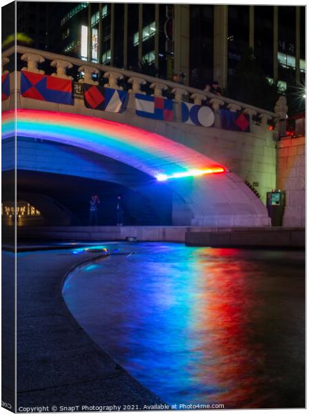 A rainbow reflecting on the Cheonggyecheon Stream at Gwangtonggyo Bridge Canvas Print by SnapT Photography