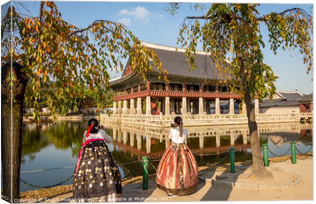 Women dressed in hanbok traditional dresses by the lake at Gyeongbokgung Palace Canvas Print by SnapT Photography