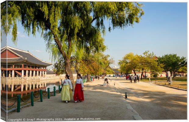Two women in hanboks walking beside the lake at Gyeongbokgung Palace, Seoul Canvas Print by SnapT Photography