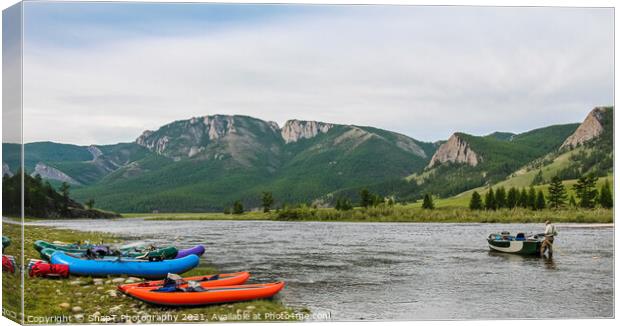 Fishing guide setting up at camp early on the river in the morning Canvas Print by SnapT Photography