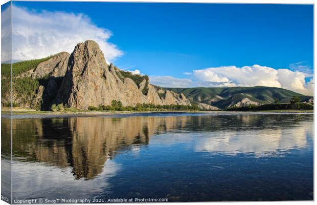 A mountain reflecting on the Delger Murun River in Mongolia in the evening sun Canvas Print by SnapT Photography