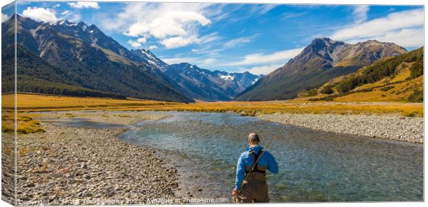 An fly fisherman looking for trout in the mountains of the Ahuriri River Canvas Print by SnapT Photography