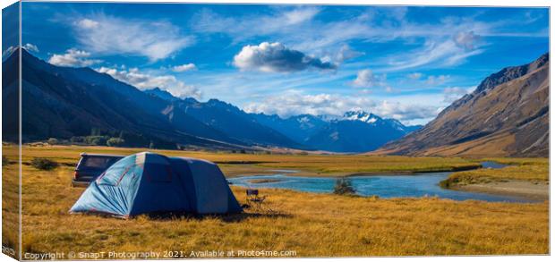A tent pitched beside a river, surrounded by mountains, in New Zealand Canvas Print by SnapT Photography