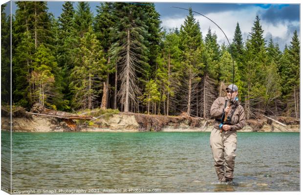 Closeup of a sport fly fisherman hooked into a salmon on a river in British Columbia Canvas Print by SnapT Photography