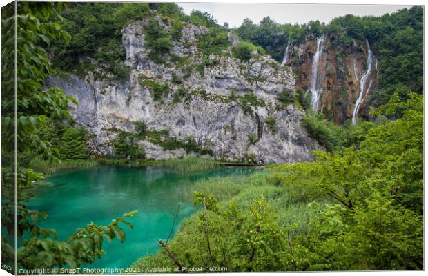 A large waterfall flowing over a mountain into a lake at Plitvice Lakes, Croatia Canvas Print by SnapT Photography
