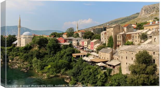 The old town of Mostar looking upstream from the historic old arched bridge Canvas Print by SnapT Photography
