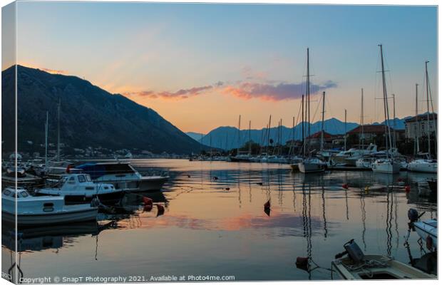 Boats moored in Kotor harbour at sunset, by the old town, Montenegro Canvas Print by SnapT Photography