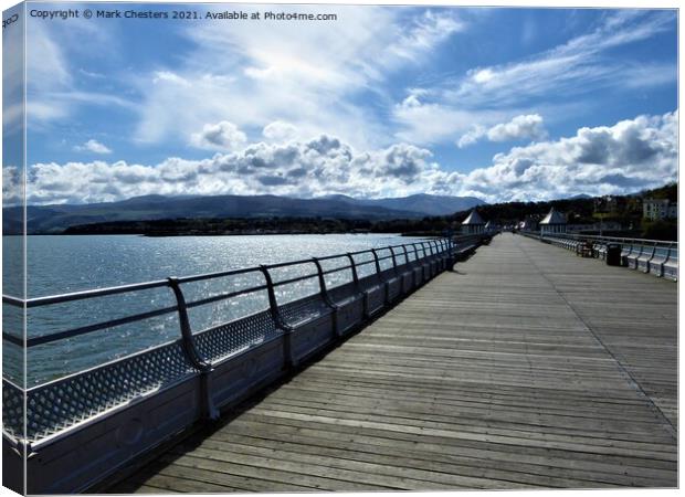 Bangor pier looking towards Snowdonia. Canvas Print by Mark Chesters
