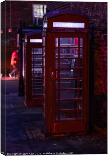Red English Telephone boxes in a night time street Canvas Print by That Foto