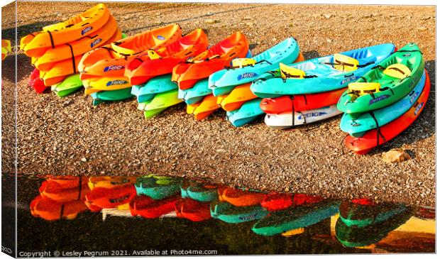 Kayaks by a Lake Canvas Print by Lesley Pegrum
