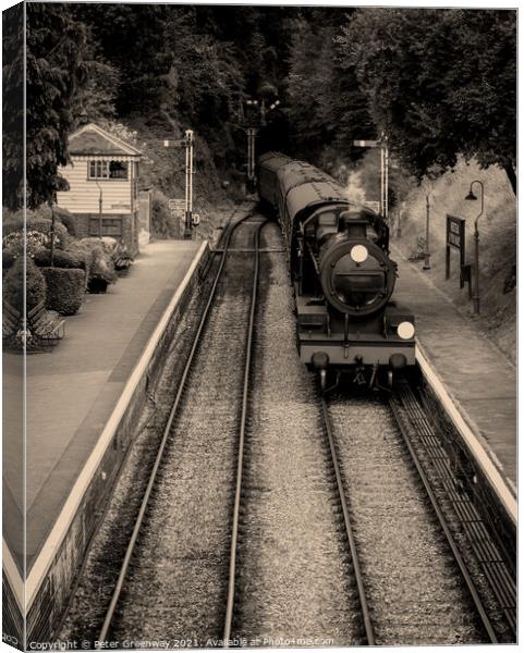 Steam Train & Carriages Arriving At A Quaint English Railway Station Canvas Print by Peter Greenway