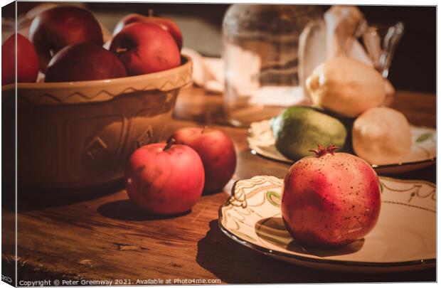 Festive Pomegranate & English Apples On A Rustic Kitchen Table Canvas Print by Peter Greenway