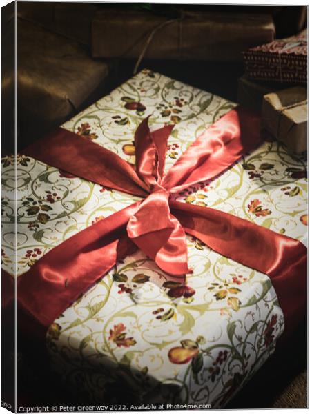 Wrapped Christmas Present Tied Up In Red Ribbon Canvas Print by Peter Greenway