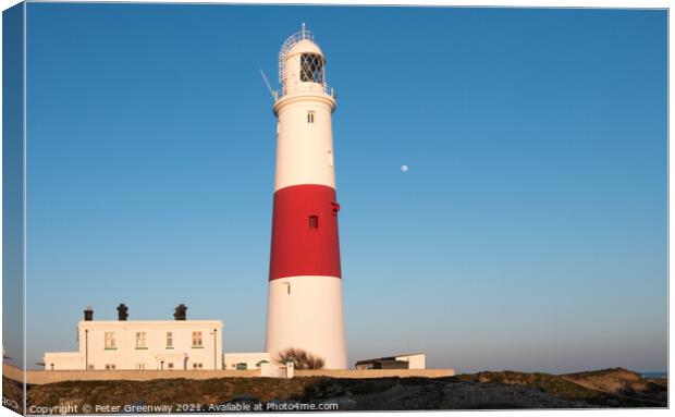 The Moon Behind The Iconic Lighthouse At Portland Bill, Dorset At Sunset Canvas Print by Peter Greenway