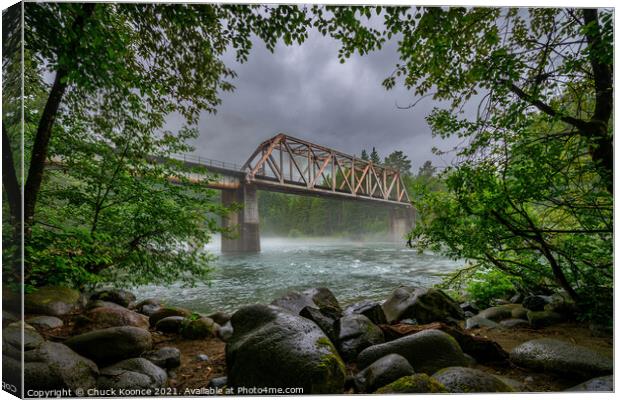 Rail road bridge over the Skykomish River Railroad in Western Washington state. Canvas Print by Chuck Koonce