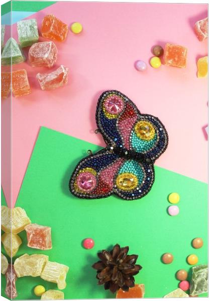 butterfly on colored paper with multicolored sweets Canvas Print by Andrei Babchanok