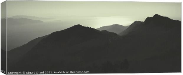 Sunset Over The Mountains Silhouette Of A Mountain Range Against The Sky Panorama Canvas Print by Stuart Chard