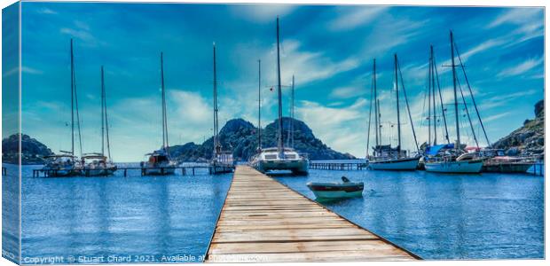 Bay with boats on a jetty Canvas Print by Stuart Chard