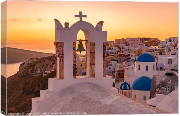 Blue domed churches and bell tower facing Aegean Sea with warm sunset light in Oia, Santorini, Greece Canvas Print by Chun Ju Wu