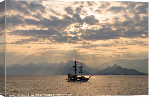 A ship sailing on the sea under the sunset heaven light Canvas Print by Chun Ju Wu