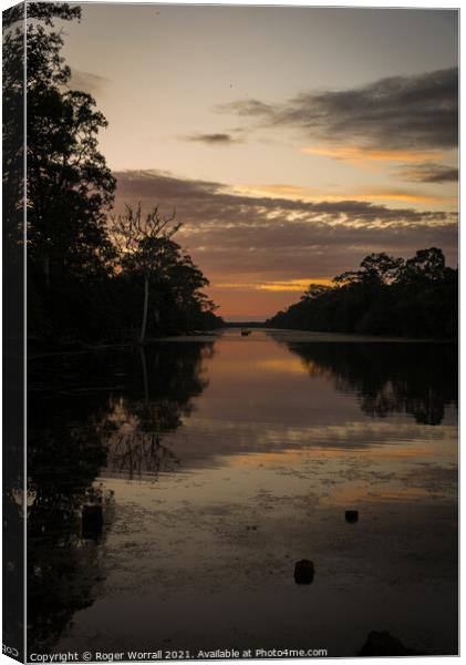 A sunset over a body of water Canvas Print by Roger Worrall