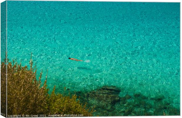 Swimming in the crystal clear sea, Halkidiki, Gree Canvas Print by Nic Croad