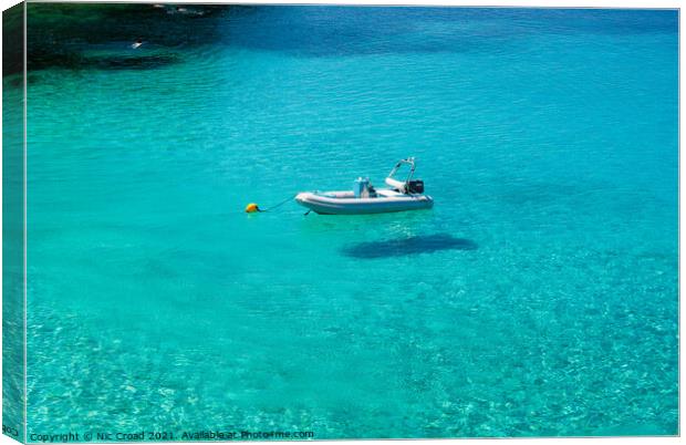 Boat floating on crystal clear water Canvas Print by Nic Croad
