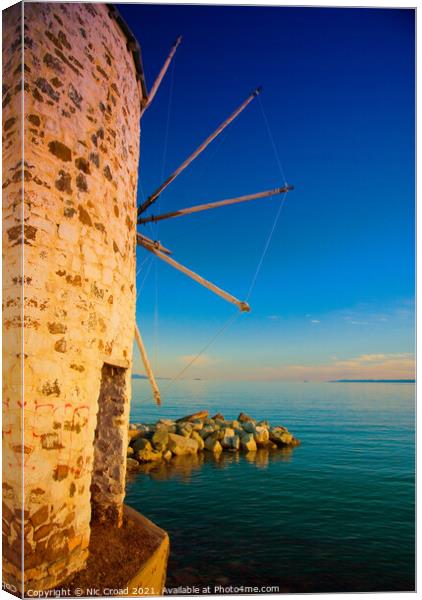 Greek windmill on the beach Canvas Print by Nic Croad