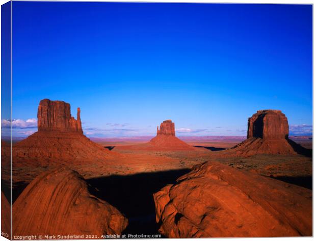 The Mittens and Merrick Butte at Sunset Monument Valley Canvas Print by Mark Sunderland