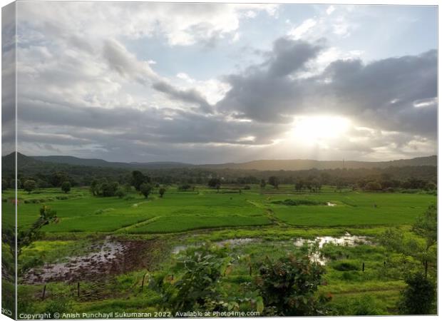 beautiful river near mountain under cloudy sky and a rice field Canvas Print by Anish Punchayil Sukumaran