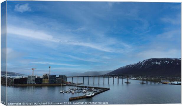 Gleaming Tromso Bridge Reflecting Clouds over the Sea Canvas Print by Anish Punchayil Sukumaran