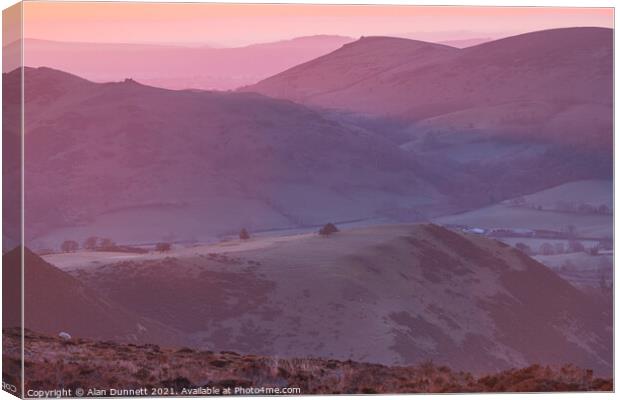 Sunrise from the Long Mynd over the Shropshire Hil Canvas Print by Alan Dunnett