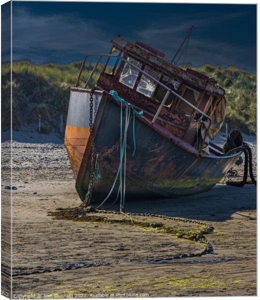 Boat on a beach Canvas Print by Alan Dunnett