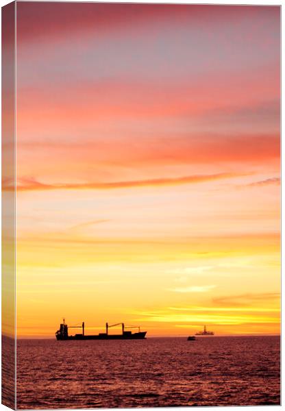 Sunset over ships waiting to enter Cape Town Harbour Canvas Print by Neil Overy