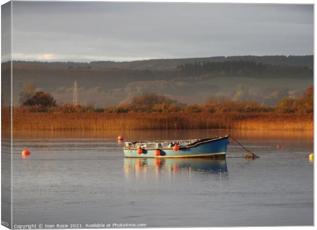 Blue boat on the Exe Estuary in early morning winter sunlight Canvas Print by Joan Rosie