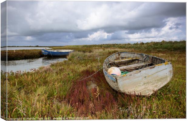 Old rowing boat on marsh grass Canvas Print by Martin Tosh