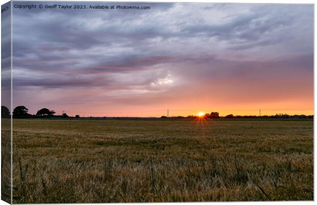 Sunset over a ripening field Canvas Print by Geoff Taylor