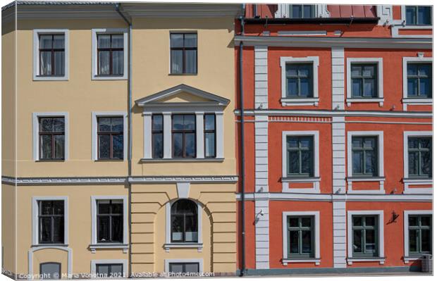 Colorful facade with yellow and red of historic buildings Canvas Print by Maria Vonotna
