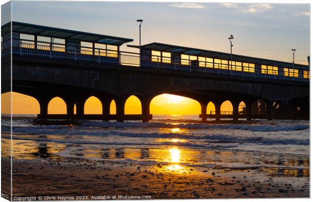 Sunrise on the sea under the arches Canvas Print by Chris Haynes
