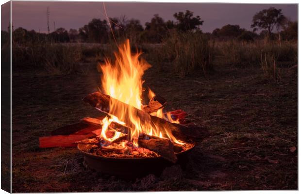 Camp Fire Burning in African Savanna at the Okavango, Africa Canvas Print by Dietmar Rauscher
