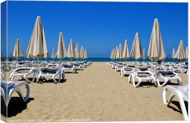 Umbrellas and chaise lounges on the sandy beach Canvas Print by Paulina Sator