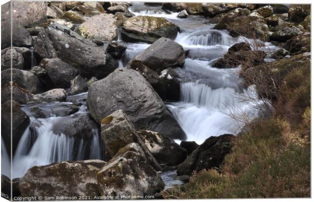 Stream flowing over rocks Canvas Print by Sam Robinson