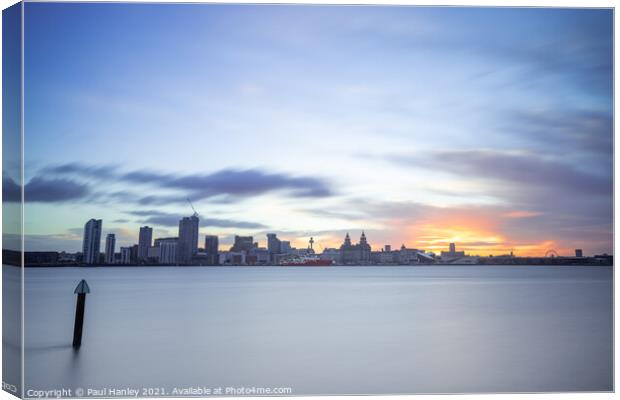 The sun rising over the skyline of Liverpool Canvas Print by Paul Hanley
