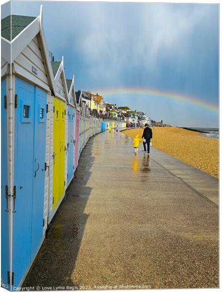 Pastel coloured beach huts Lyme Regis with a rainbow Canvas Print by Love Lyme Regis