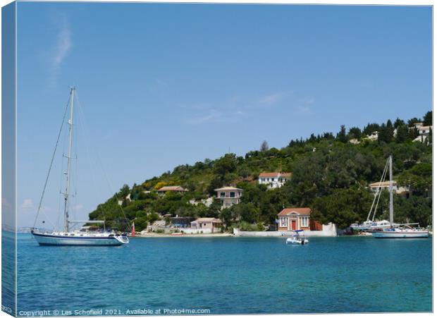 Boats in harbour at Paxos Greece  Canvas Print by Les Schofield