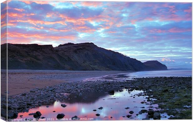 A Golden Sunrise at Charmouth Beach Canvas Print by Les Schofield