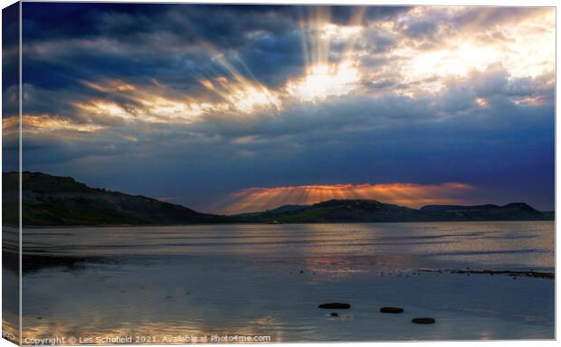 Charmouth Sunrise over Golden Cap Canvas Print by Les Schofield
